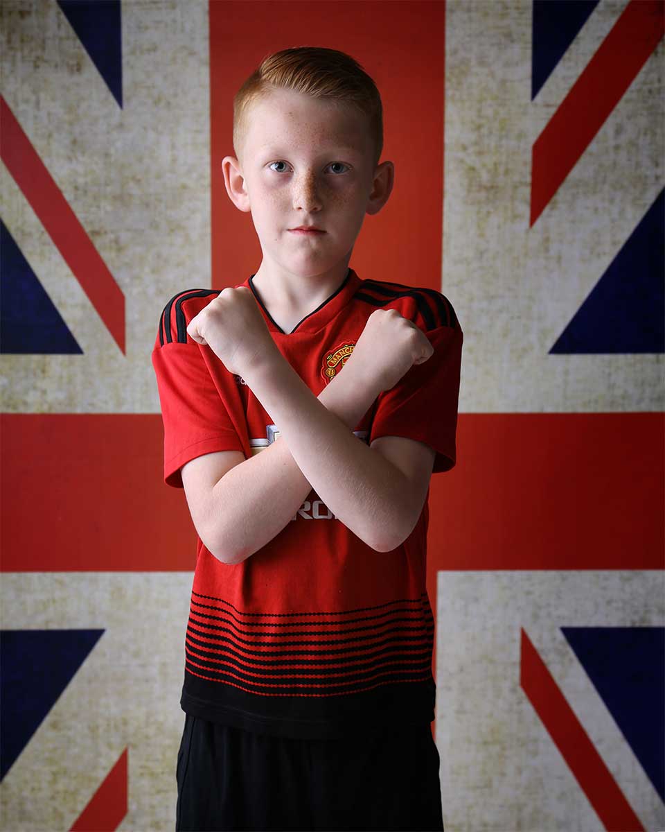 boy in football kit at children's photo shoot